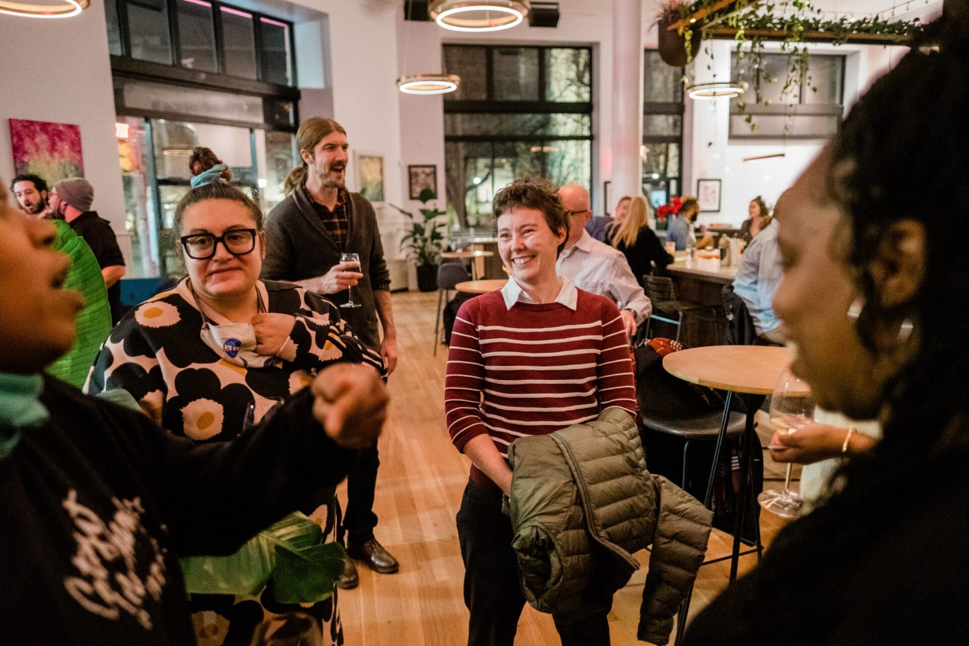 A group of educators engaged in conversation at a Remake Learning happy hour for working group members.