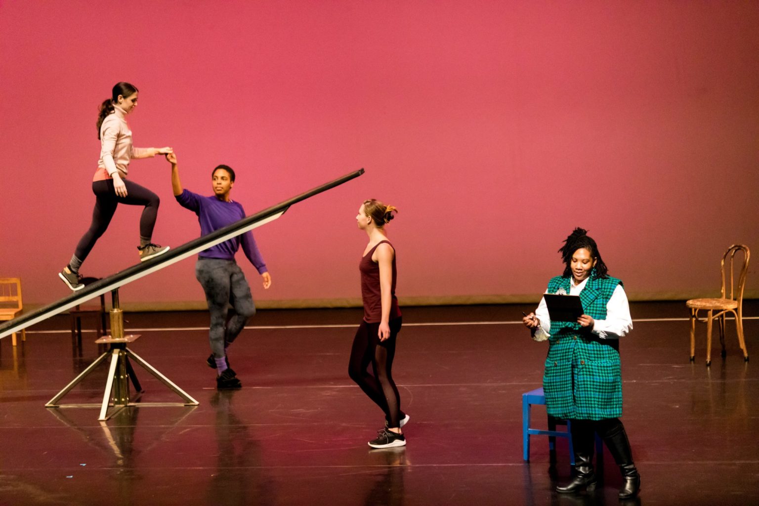Four students perform on a stage.