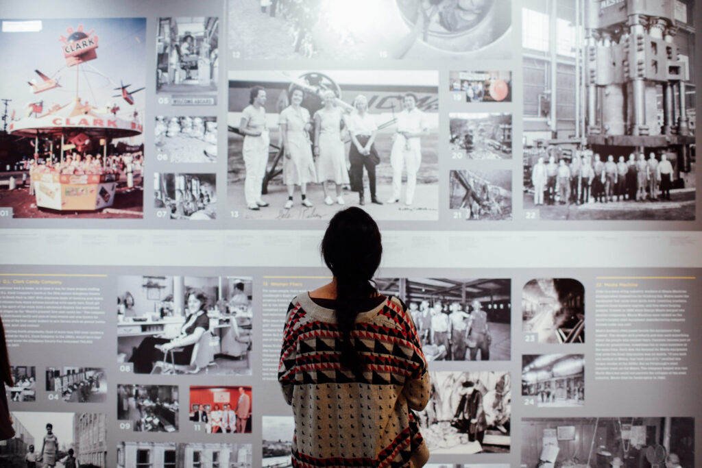 A young woman standing in front of a display at the Heinz History Center as part of the Green City Remix project