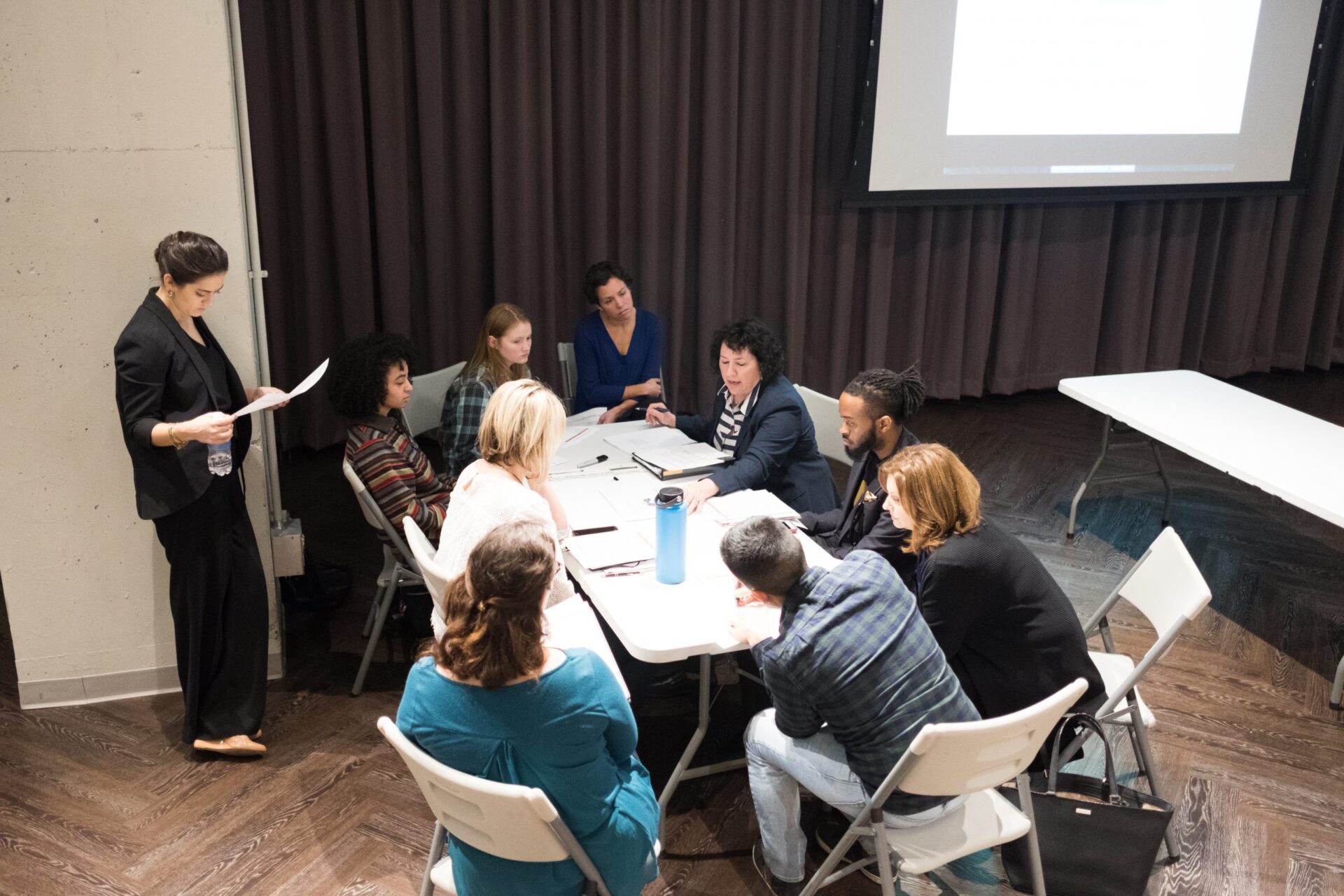 A group of people in discussion at a meeting