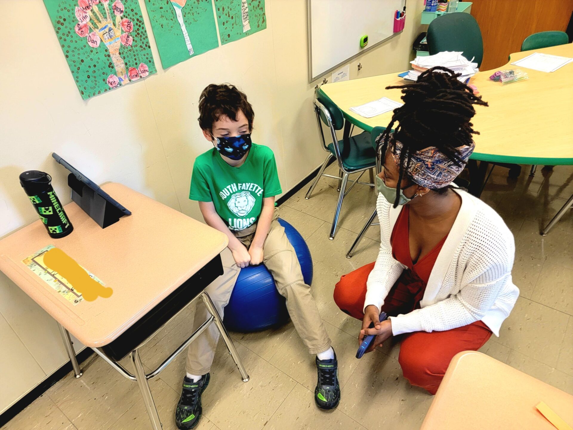 An undergraduate education student from Howard University talks with a student at South Fayette School District during the inaugural OTIS visit.