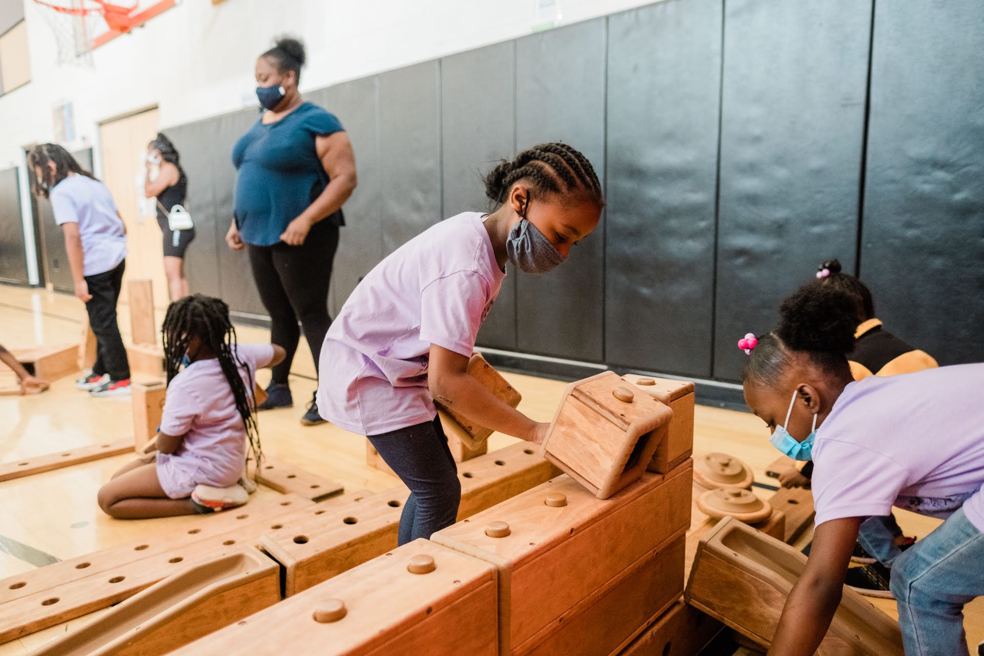 Students play with building blocks in the gym at PPS Faison