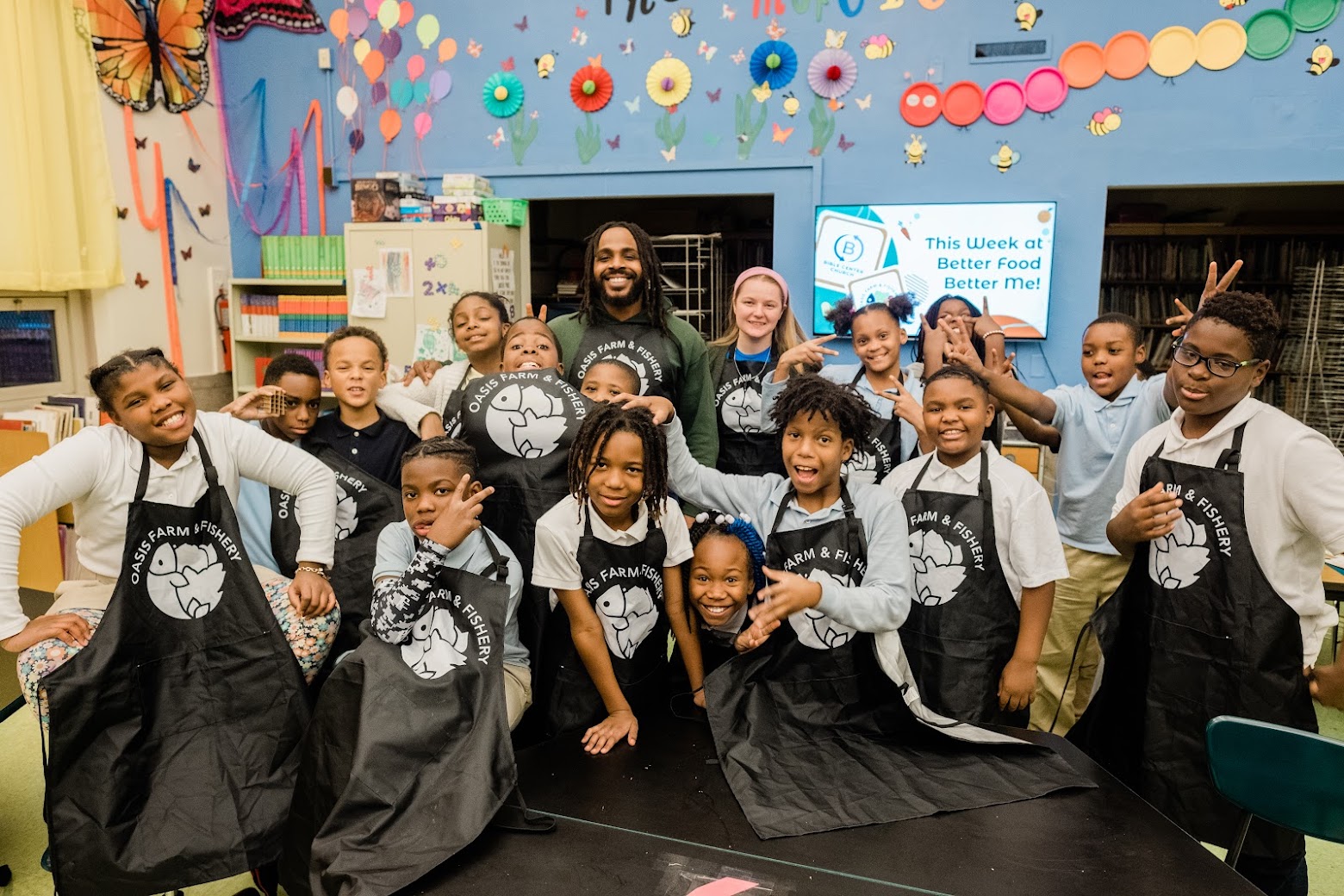 Students pose as a group during a program of Oasis Farm & Fishery's Moonshot grant