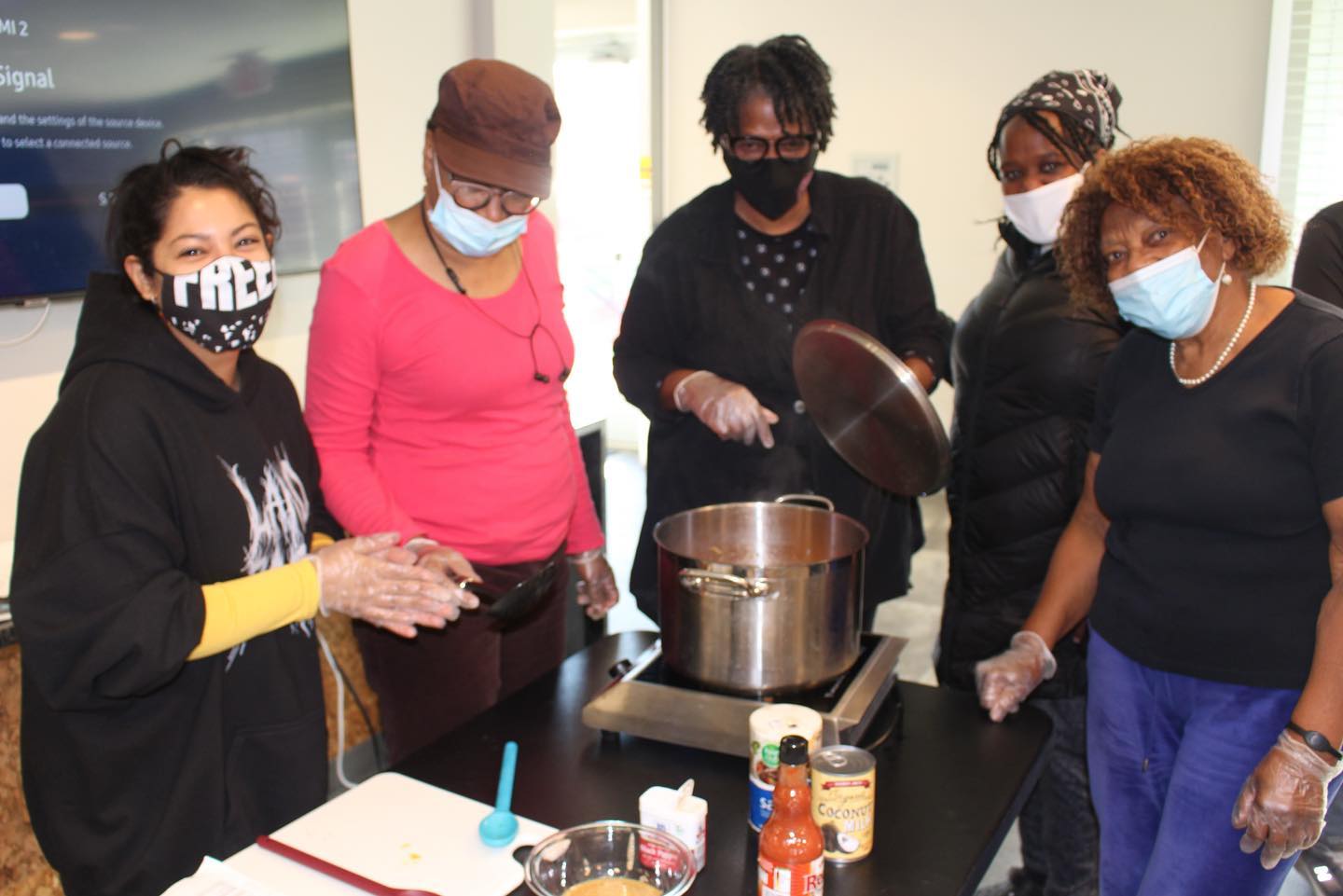 A group of women cooking and learning together