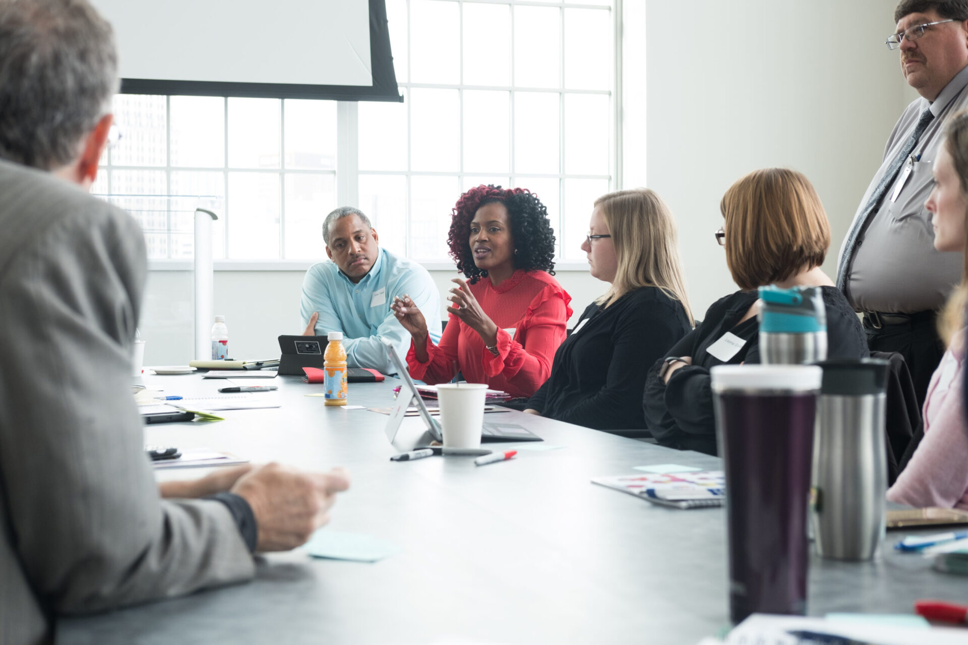 A woman speaking to a group of people at the summit.