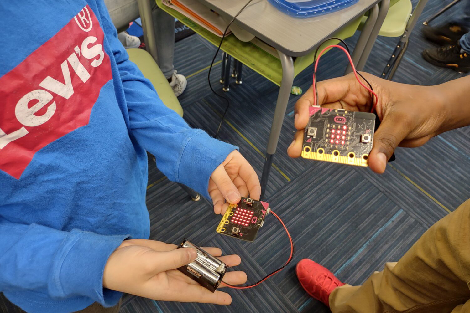A student working with circuits as part of the CMU STEAM Outreach program