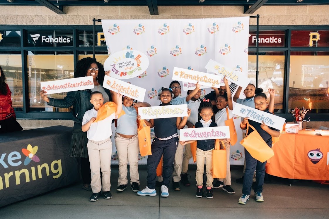 Young learners stand with their teacher to take a photo at the Remake Learning Days kickoff in 2017