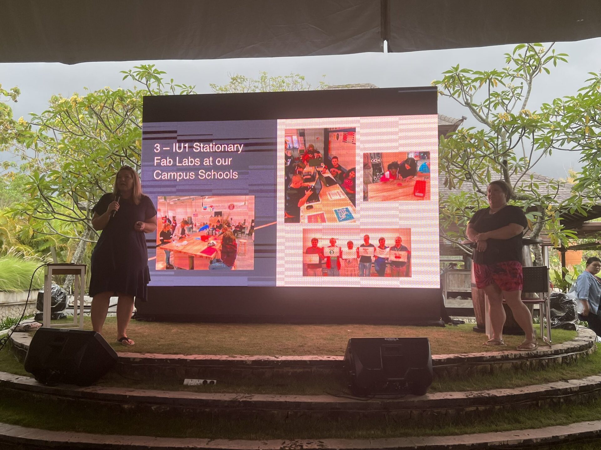 Two women give a presentation on stage at the Bali Fab Fest