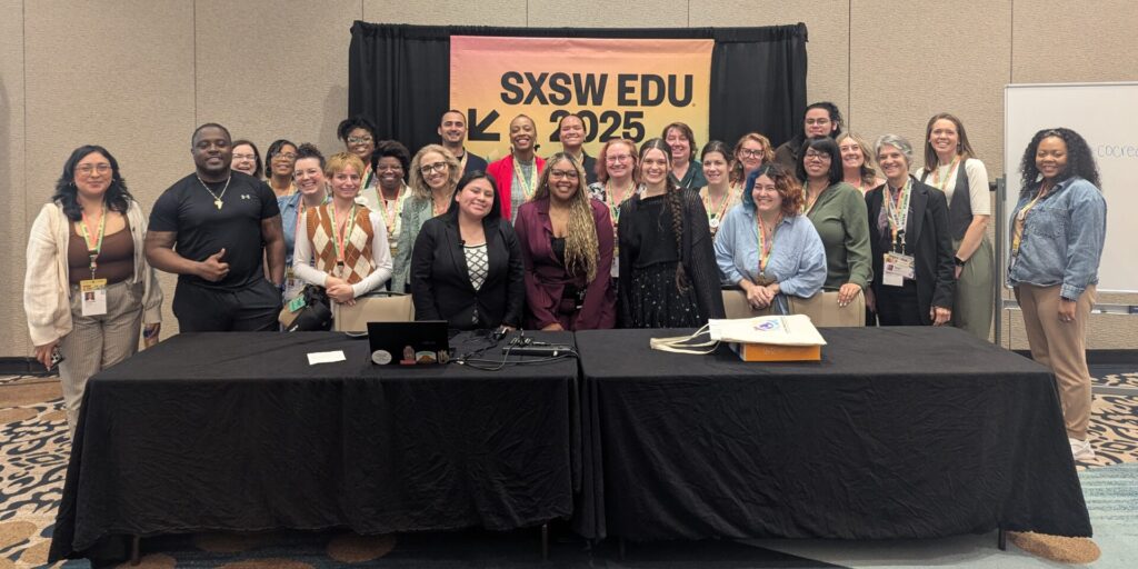 A group of about 25 people pose in front of a banner at SXSW Edu