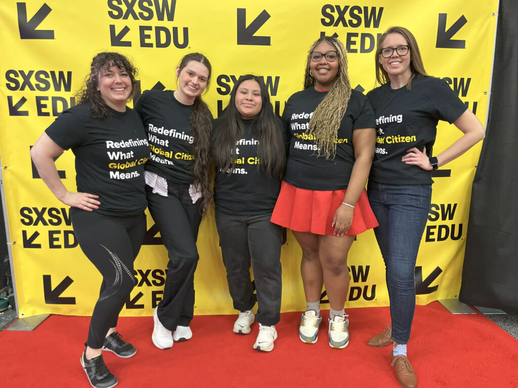 A group of five young women posing in front of a banner at SXSW EDU